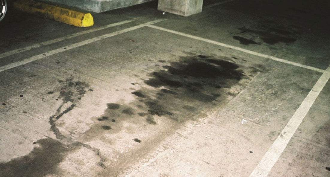 oil spill on concrete floor in garage