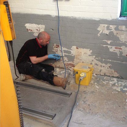 Man preparing wall for coating